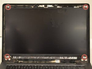 Screws hold the laptop screen to the lid