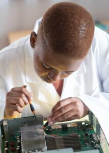 African american engineer conducting hardware diagnostic in repair shop