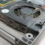 Laptop fan choked with fluff and debris