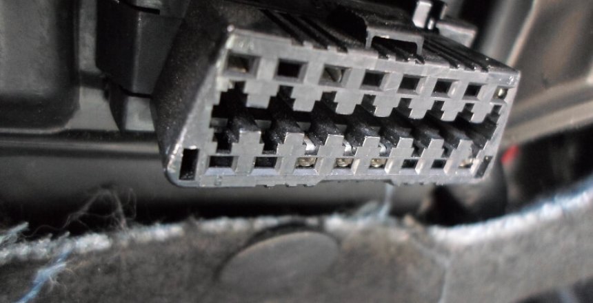 Onboard Diagnostics (ODB-II) port on a vehicle used to connect a cable to a reader to read the car's diagnostic information