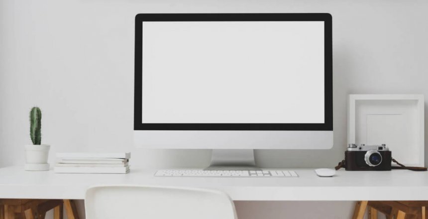 desktop computer beside analog camera